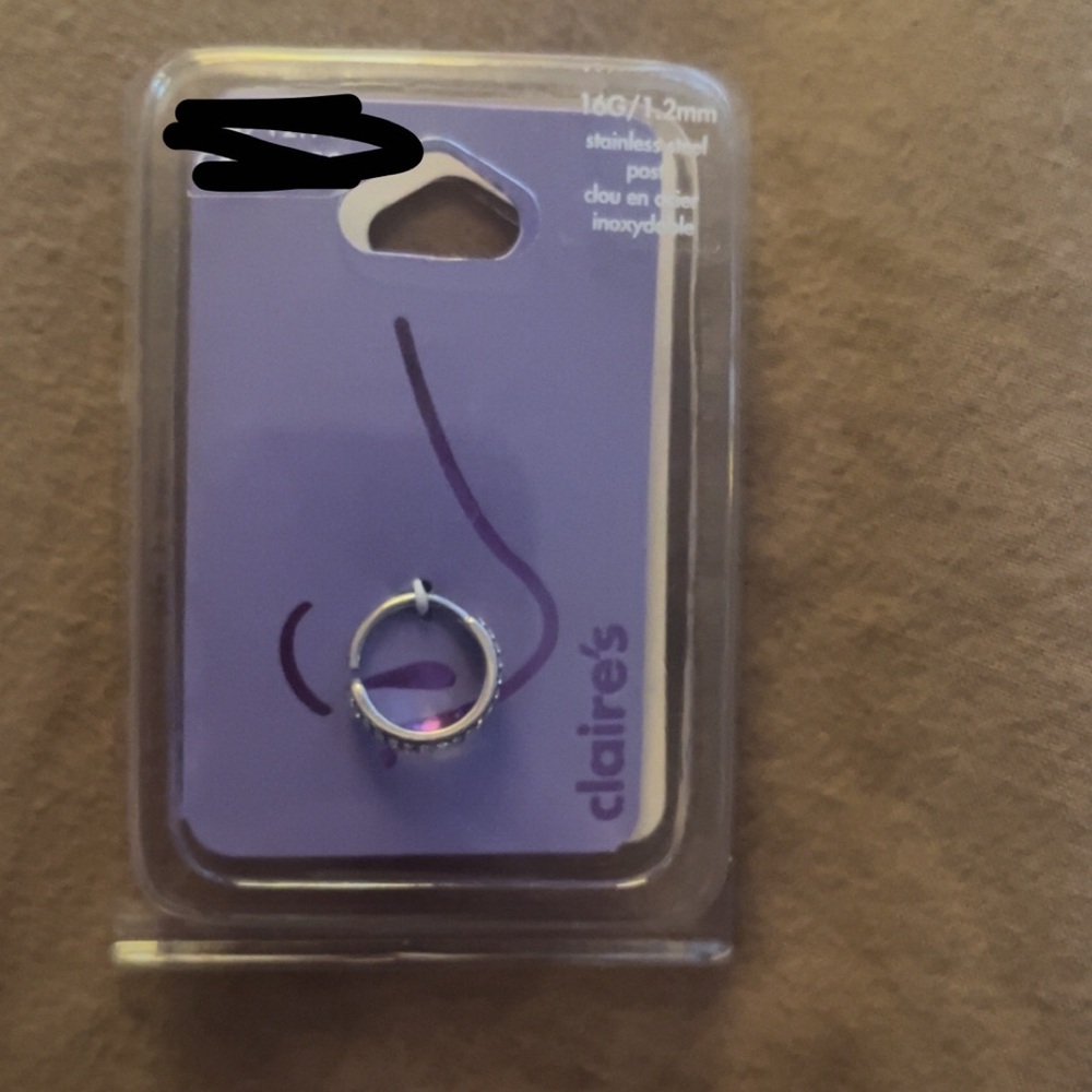 Unopened stainless steel 16G nose ring.